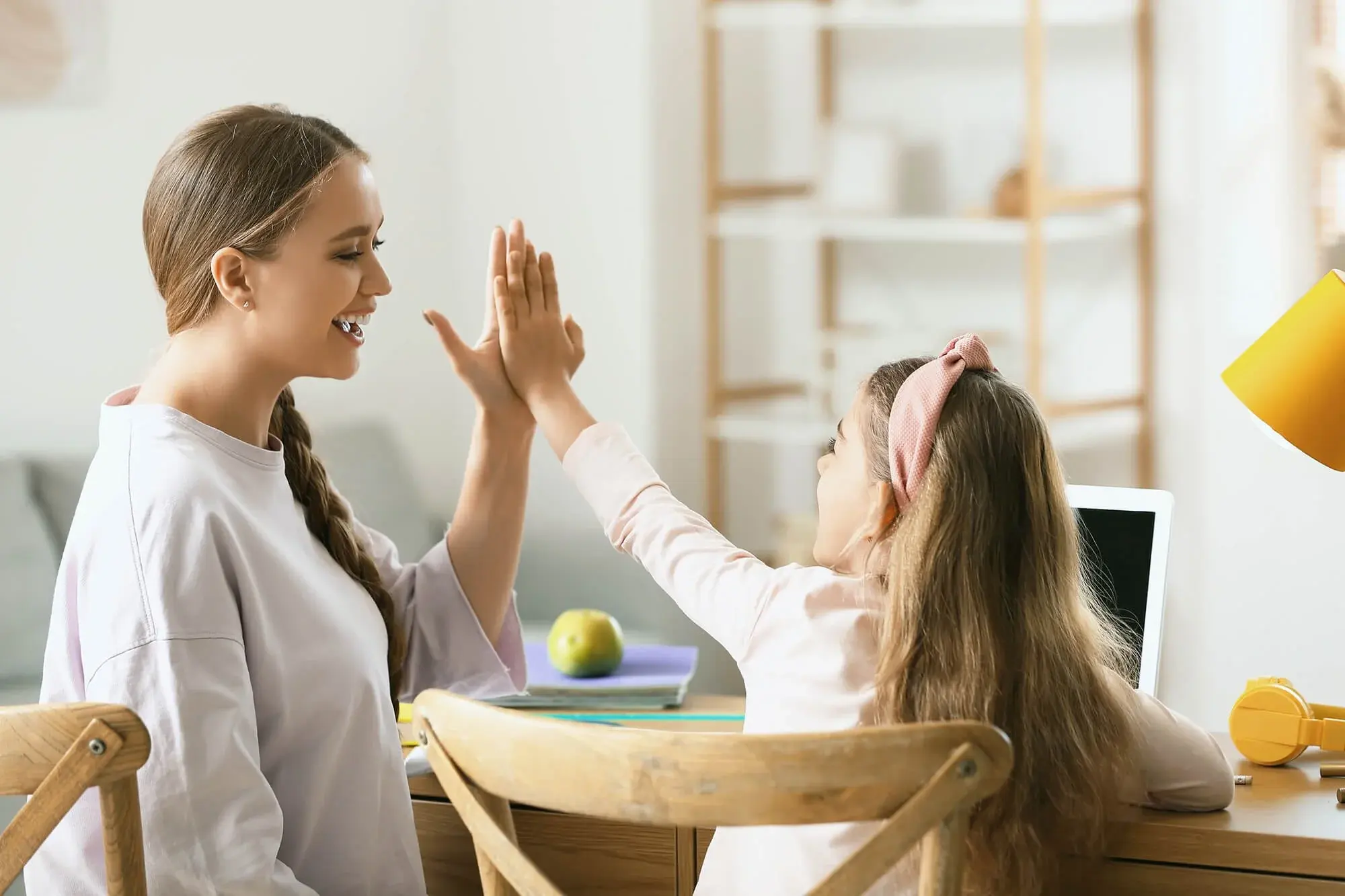 Teacher and child high-fiving